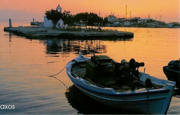 Fishing boat and harbour in Naxos Town at sunset